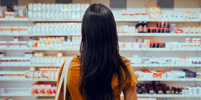 woman in store looking at supplements